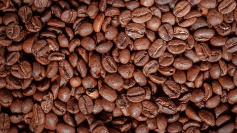 close up of seeds of coffee. fragrant coffee beans are roasted smoke comes from coffee beans.