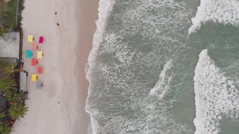 top view of the sea, drone footage , cloudy day, waves, landscape of juquehy beach, ubatuba, northern coast of são paulo, brazil