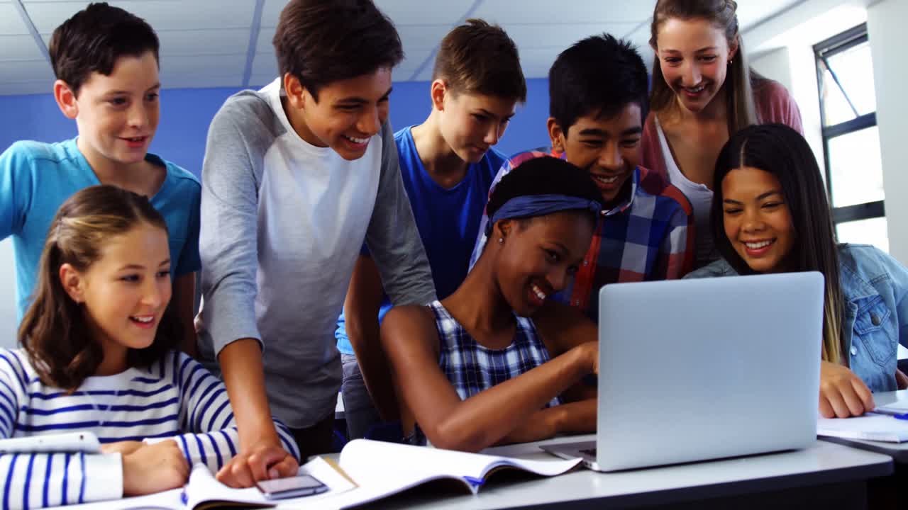 Group of students using laptop in classroom
