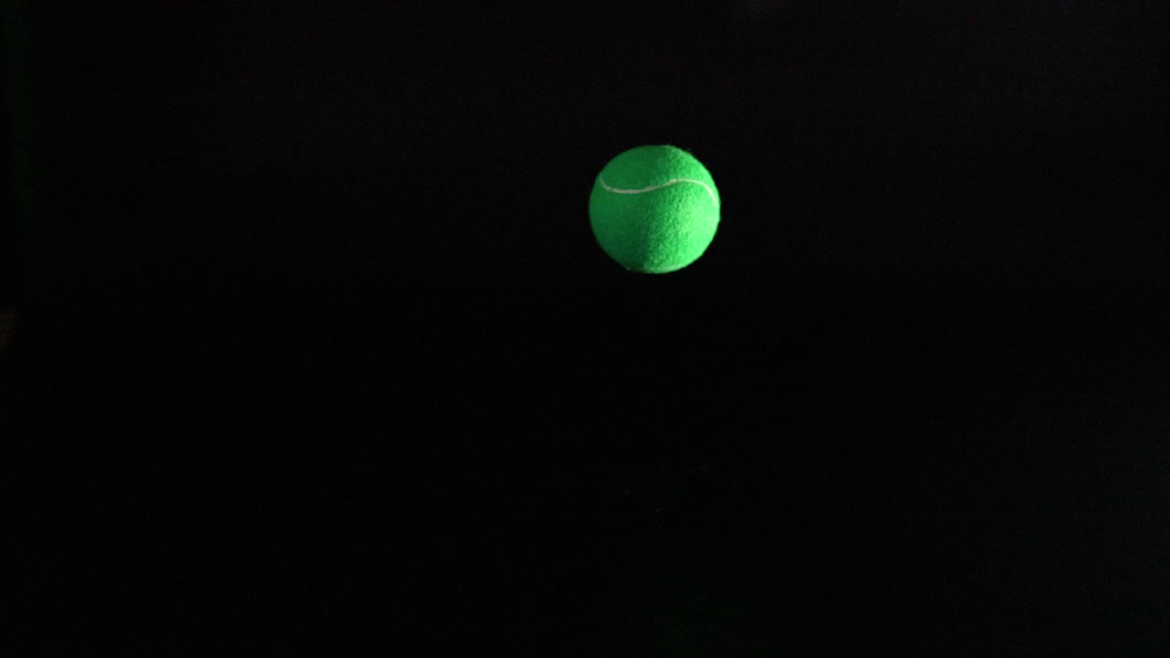 A tennis ball bouncing on a surface
