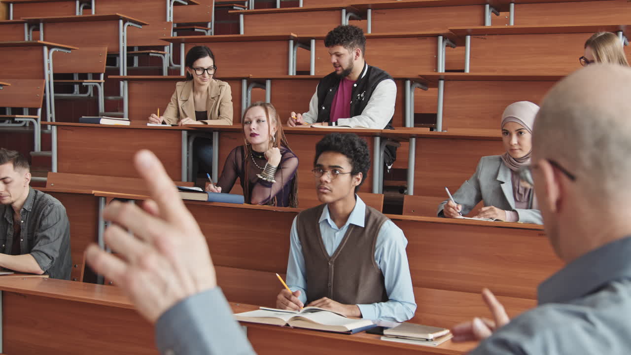 Multiethnic Students Listening to Male Professor Giving Lecture