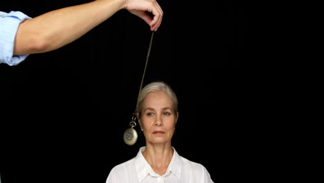 woman mesmerised by a pendulum movement