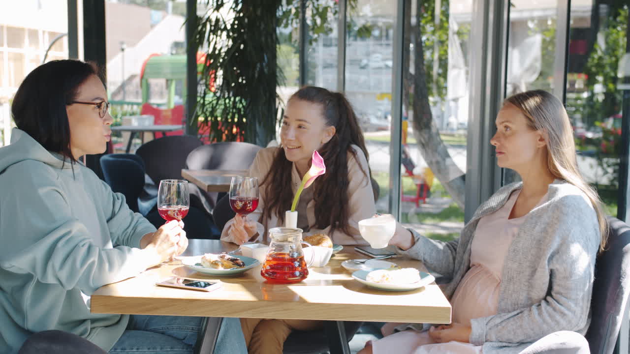 Friends enjoying a meal and conversation in a cafe
