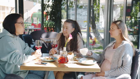 friends enjoying a meal and conversation in a cafe