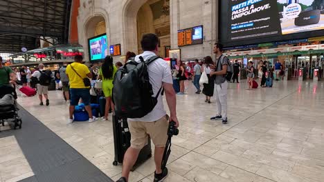 travelers navigating through milan train station