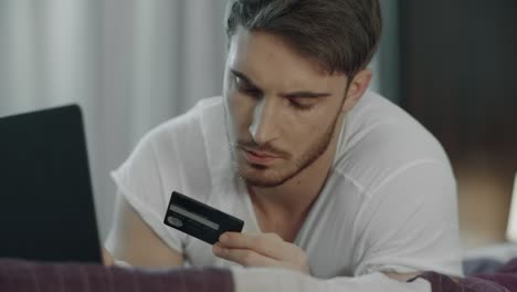 Man-using-credit-card-for-online-payment-on-computer.-Technology-purchase