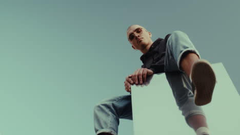 stylish man sitting on a mirror