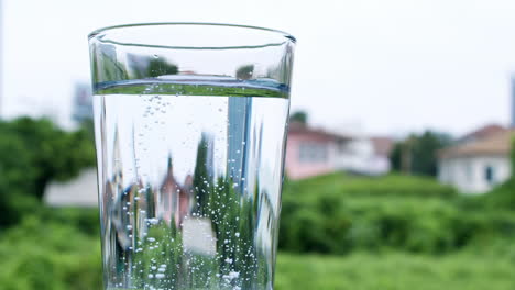 dropping a tablet of antacid into a glass of water that burst into tiny bubbles in the water