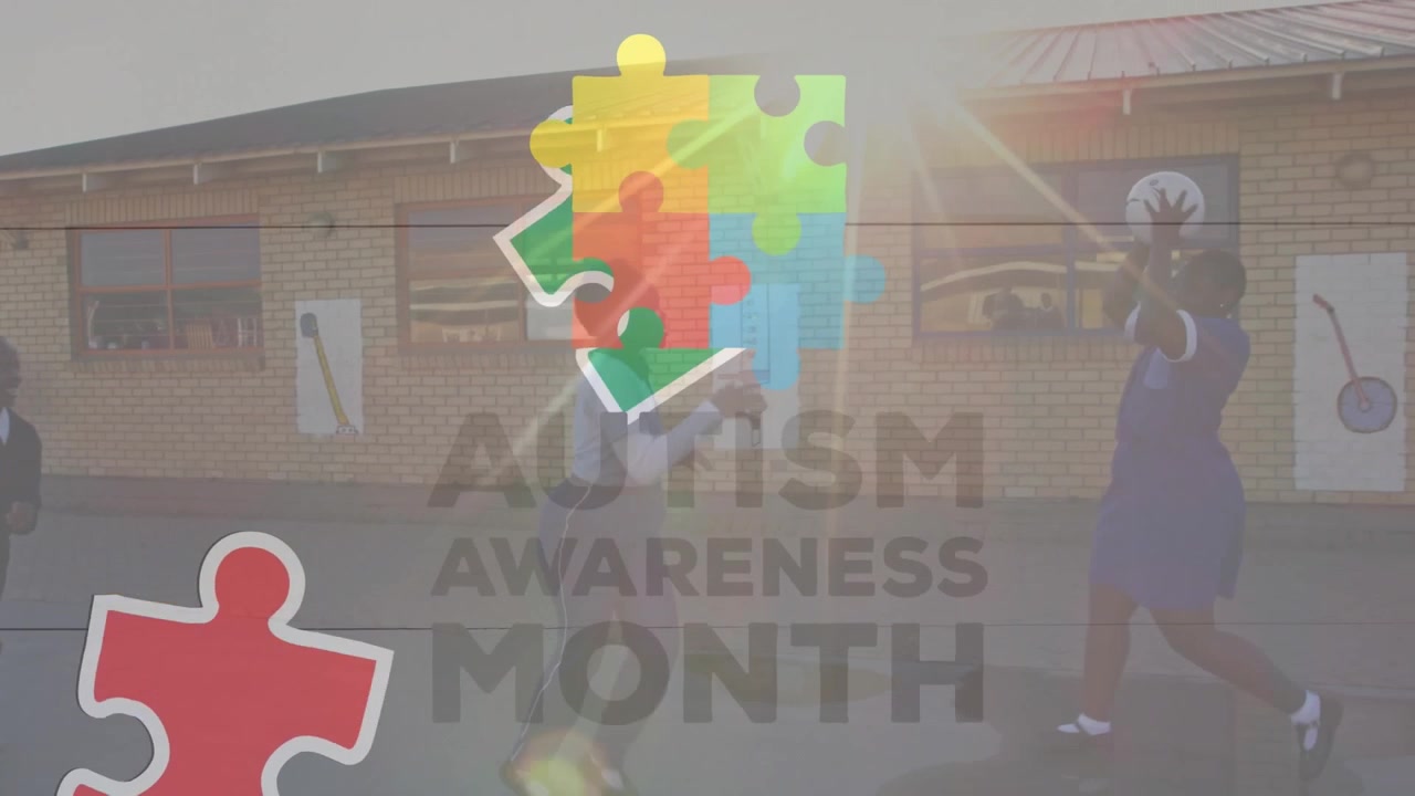 Animation of puzzle pieces and autism awareness month text over diverse schoolchildren