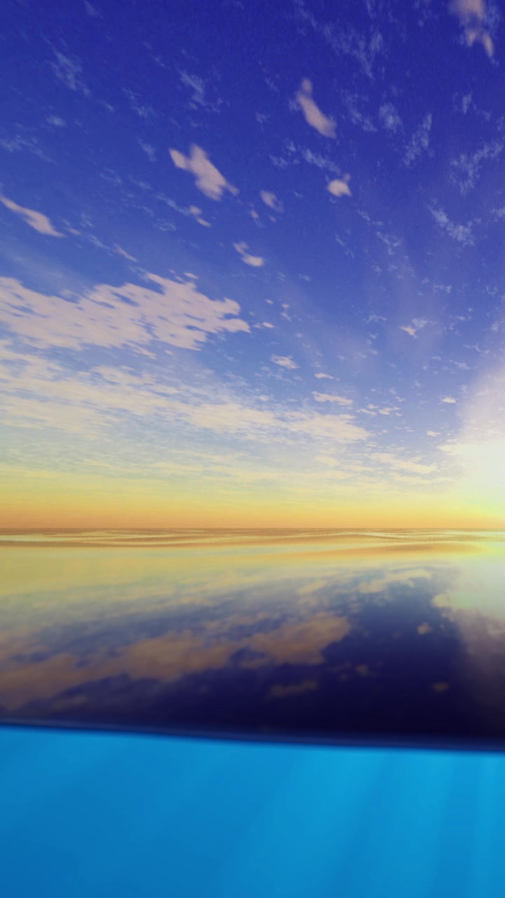Sunset over a calm sea reflecting bright colors and clouds in the sky