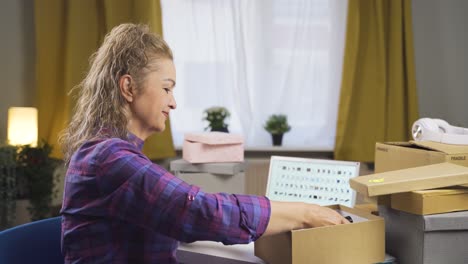 entrepreneur packaging her products for sale. e-commerce.