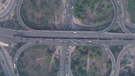 aerial birds eye view of the iconic cloverleaf interchange of maduravoyal flyover bridge in chennai captured by drone on a hazy morning with smooth flowing traffic