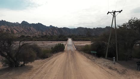 scenic bridge over a dry riverbed in the mountains
