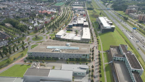 Aerial-over-busy-industrial-terrain-with-a-lot-of-traffic-on-the-road