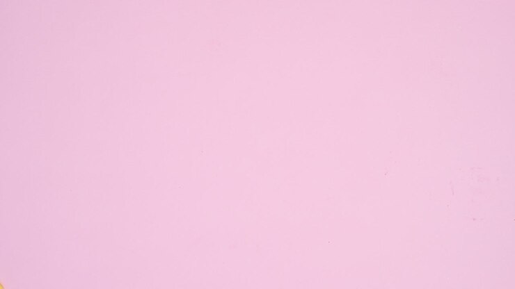 Candies chocolates, gummy candies and lollypops appear on left and right side of pastel pink background. Stop motion animation flat lay