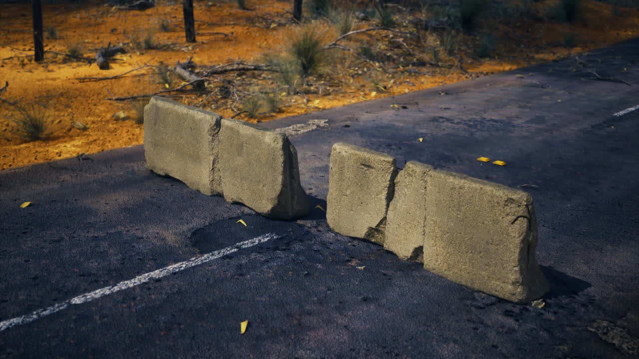 사막 풍경에서 큰 콘크리트 블록으로 만들어진 도로 장애물