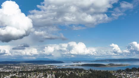 wide panning aerial shot of the cloudy and blue sky above whidbey island's oak harbor