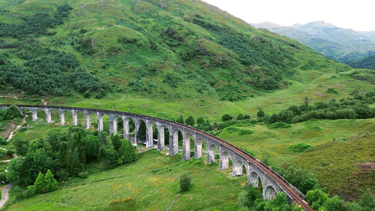 Orbit drone shot of Glenfinnan Viaduct during the day at Glenfinnan, in the Lochaber district of north-western Scotland, UK