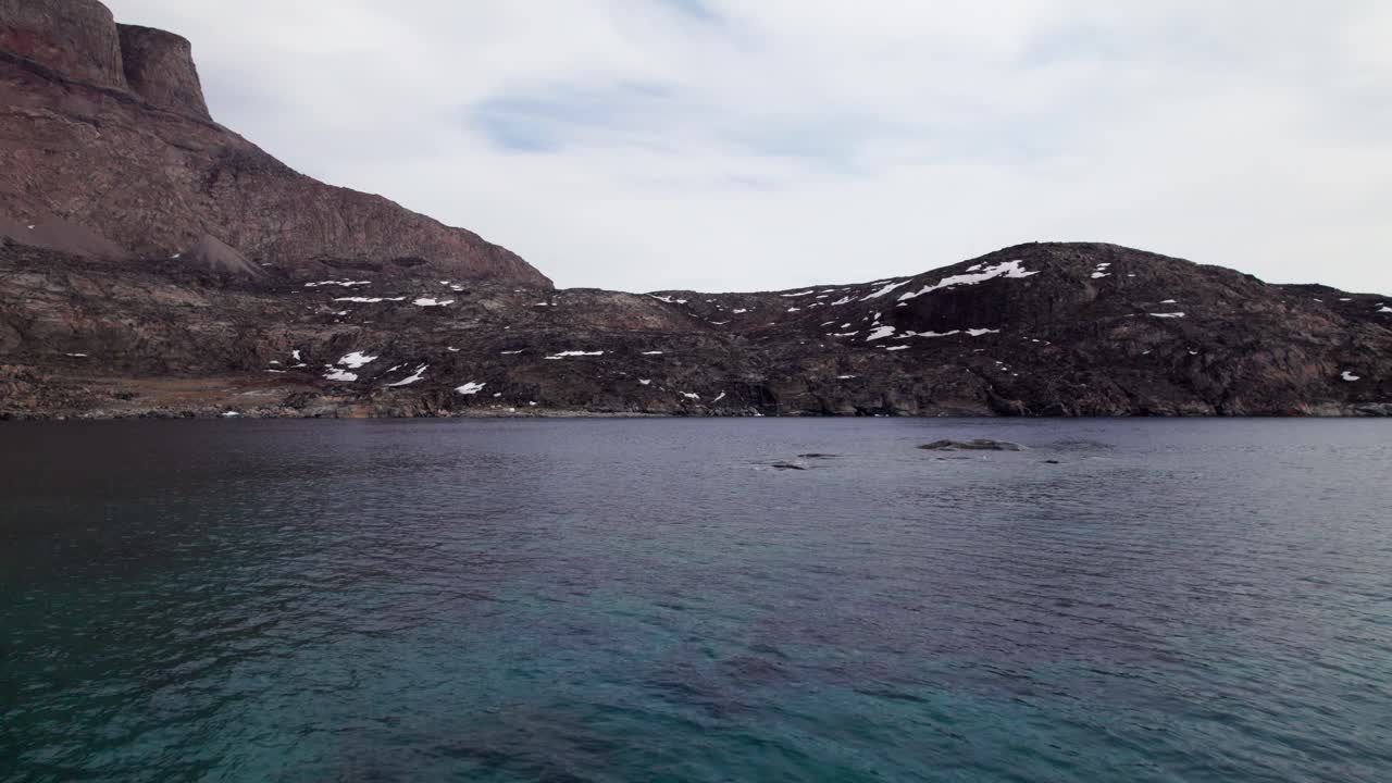 Drone Flying Through an Iceberg in Uummannaq Greenland - Dolly Forward Shot