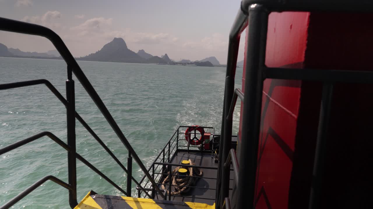 View from a ferry cruising off Koh Samui, Thailand, with serene turquoise waters and distant mountains. Concept of island transport, coastal travel, and tropical adventure by sea.