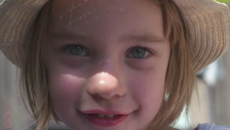 close up portrait of a beautiful little girl smiling in the sunlight