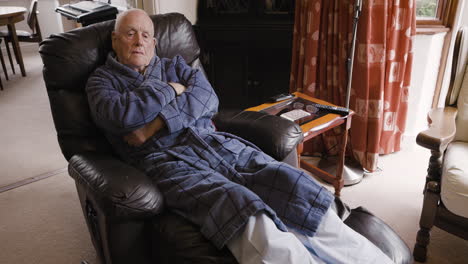 elderly man sleeping in recliner