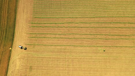 top view of the field and tractor working on it. agricultural machine on the natural rural landscape in summer. aerial view.