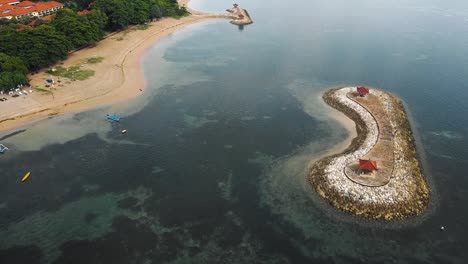 beautiful cinematic sanur beach, bali drone footage with interesting landscape, fishing boats and calm weather