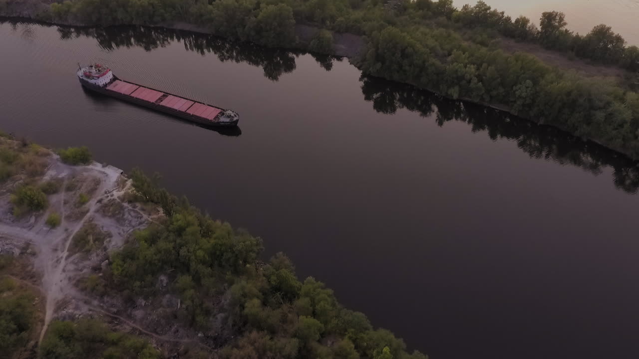 long comercial ship navigating over the waters of Dnipro river in Ukraine
