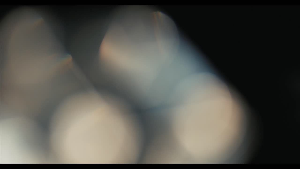 Soft Optical Light Leaks and Bokeh Moving on Dark Background