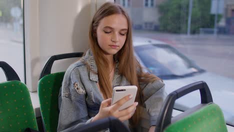 Exhausted-woman-citizen-playing-on-smartphone,-chatting,-texting,-falling-asleep-in-public-transport