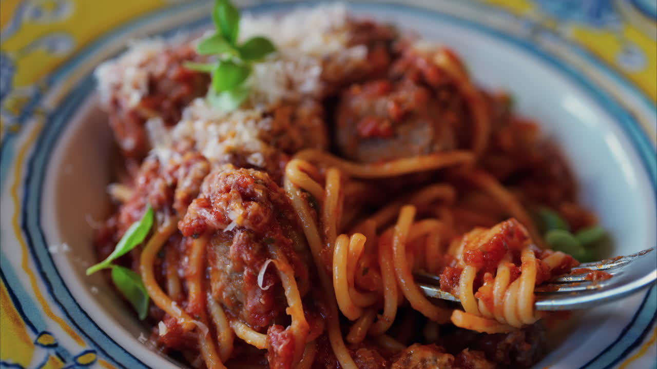 Close up of a woman eating pasta at an italian restaurant