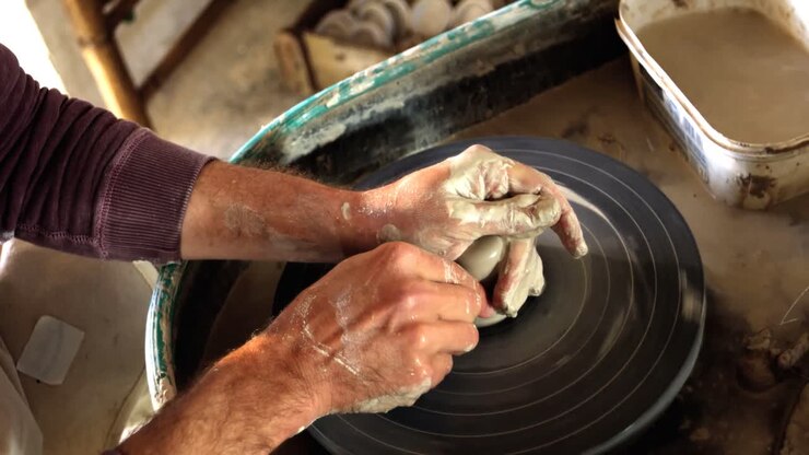 Mid section of potter making pot
