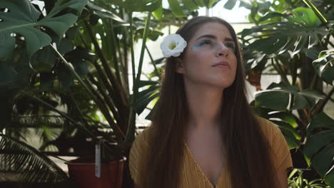 young girl model looking around in greenhouse