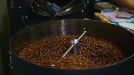 Freshly-roasted-coffee-beans-tipped-into-cooling-plate-for-stir-cooling