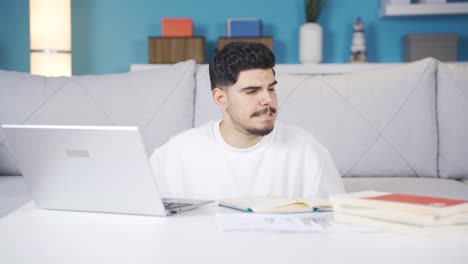 Nervous-college-teenager-suddenly-turns-off-laptop.-He-is-biting-his-nails.