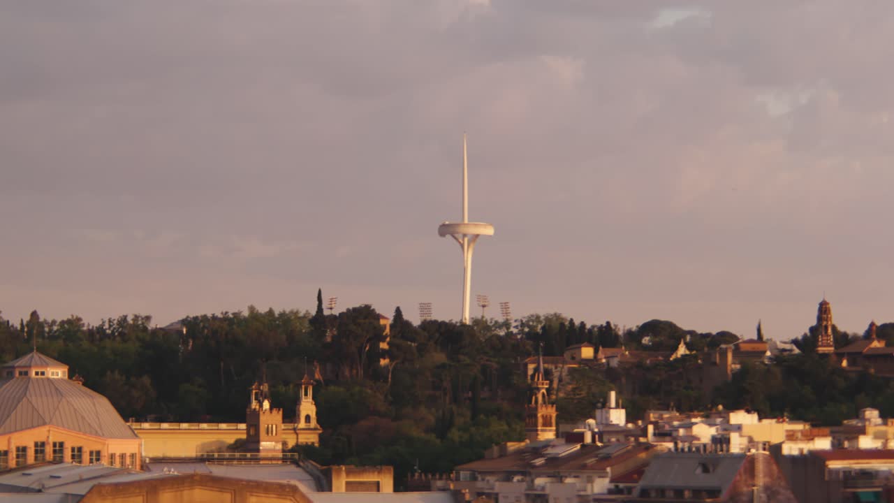 Fixed shot on Montju&iuml;c Communications Tower above Barcelona during morning