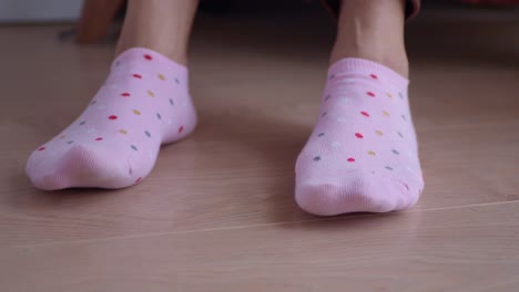 pink polka dot socks on a wooden floor