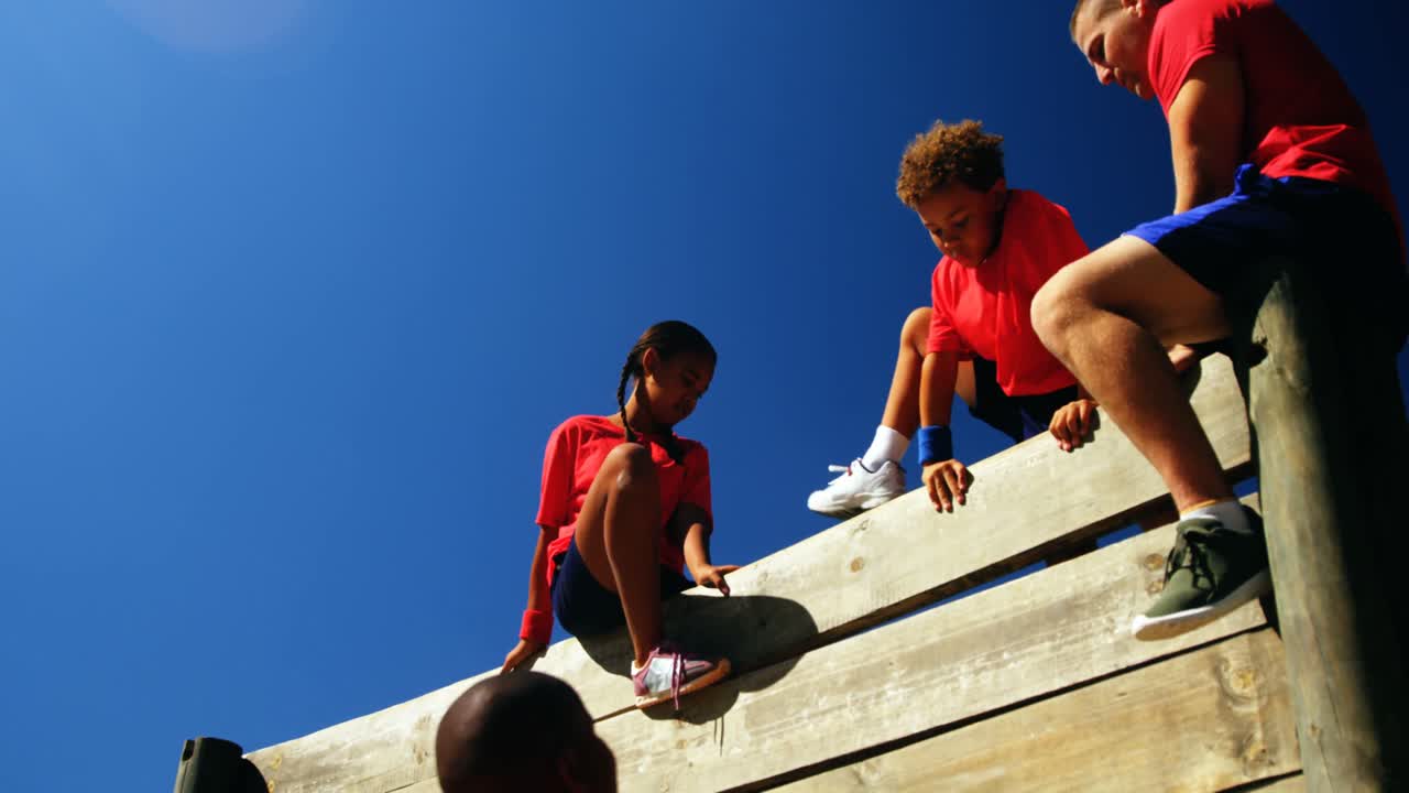 Trainer training kids in the boot camp