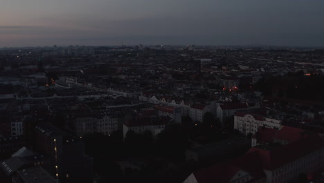 Slow-forwards-fly-above-urban-neighbourhood.-Aerial-view-of-streets-and-buildings-in-city-before-sunrise.-Berlin,-Germany