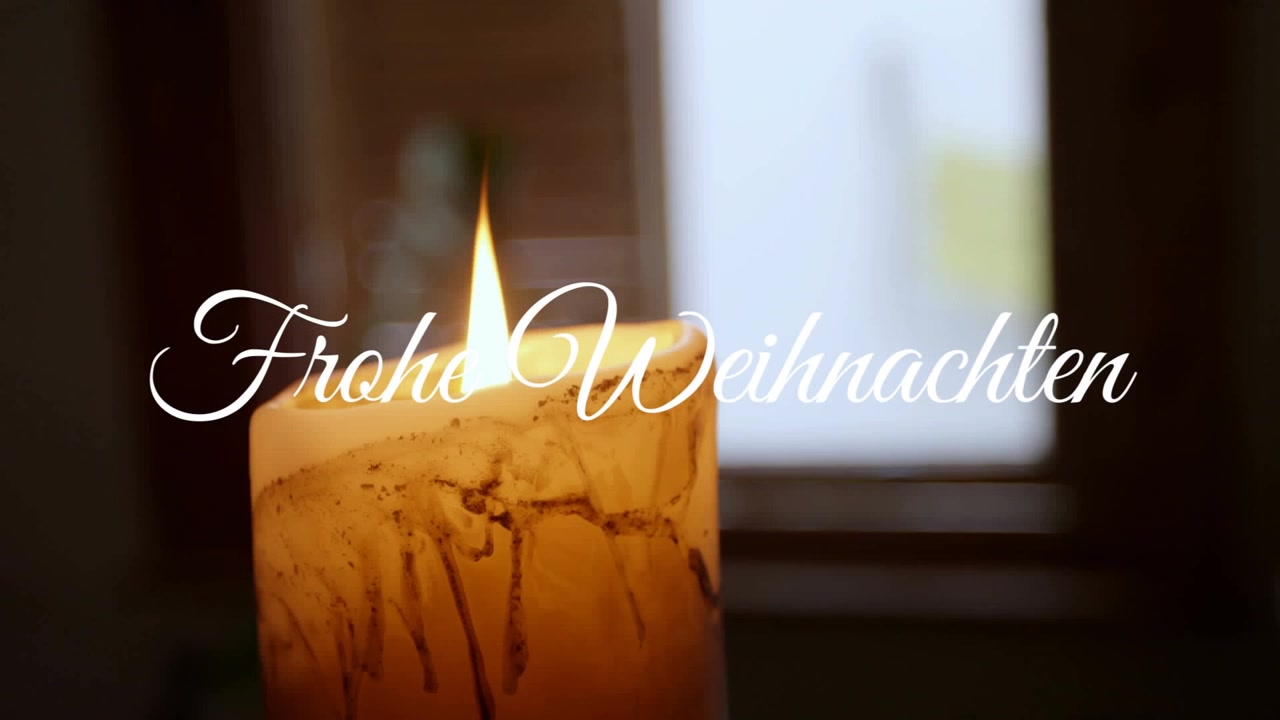 Animation d'un texte de vœux de Noël "Frohe Weihnachten" sur une bougie
