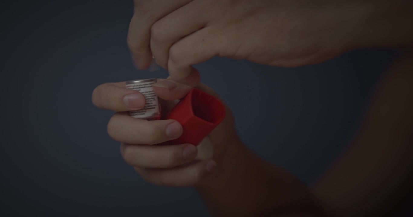 Athlete having an asthma attack and grabbing inhaler with blurry vision