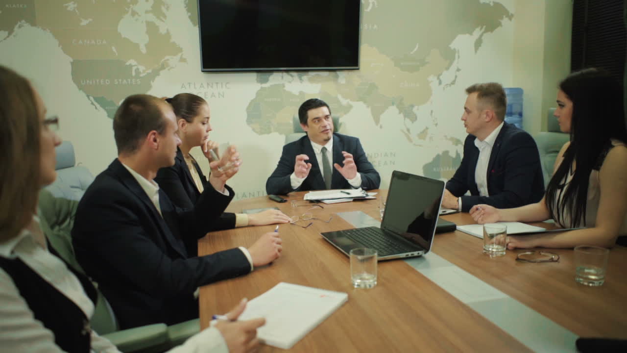 Business People Discussing Together. Business partners discussing documents and ideas at meeting