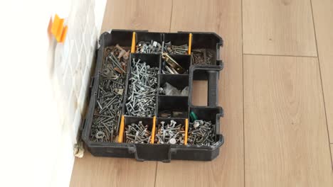 assorted hardware and tools in storage box