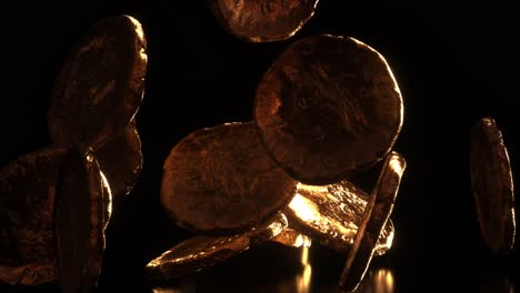 golden and shiny ancient roman coins falling on black background