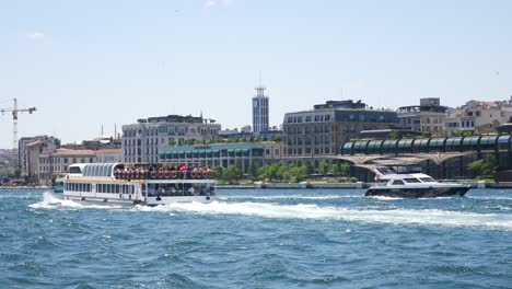 a boat full of tourists sailing on the water with a view of istanbul, turkey