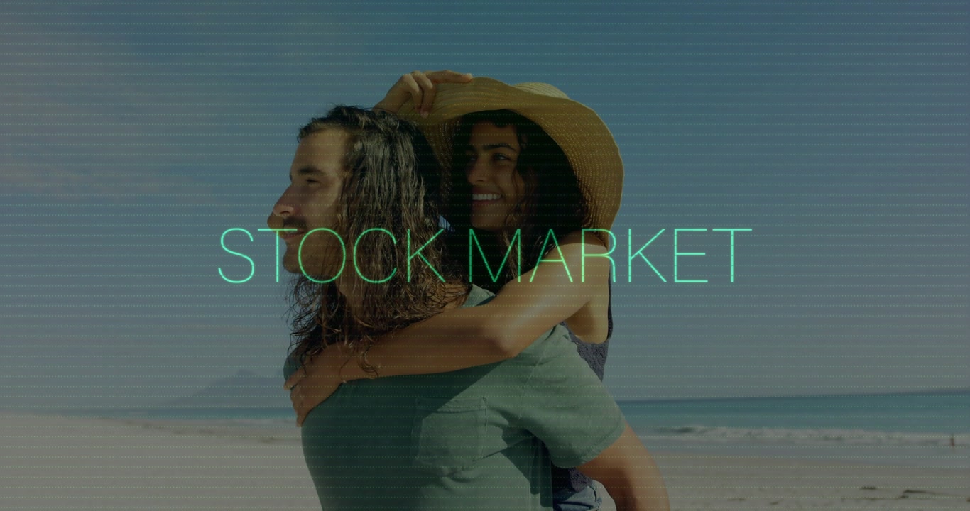 On beach, couple relaxing with stock market animation overlay, enjoying scenery