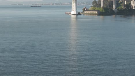a drone gimbal panning upwards to reveal the san francisco bay bridge.
