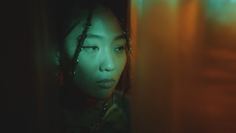 pretty asian woman posing in studio with neon light and no signal tv