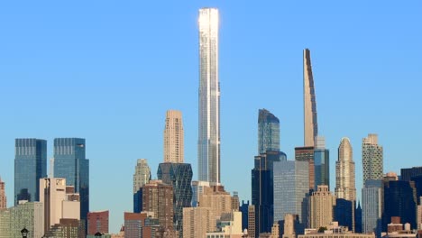 manhattan skyline buildings close up during bright day with clear blue sky